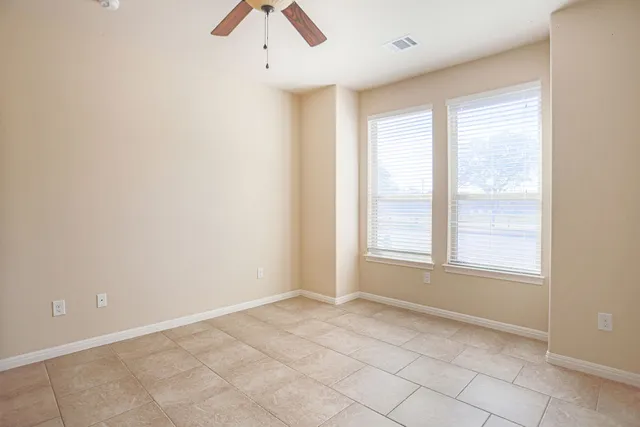 an empty room with a empty space and windows