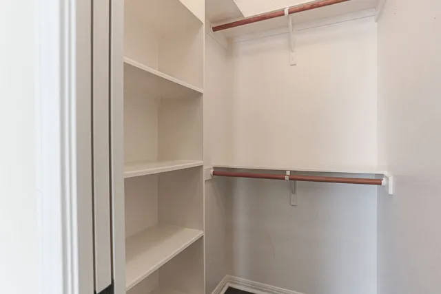 a view of an empty walk in closet with empty racks