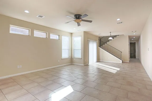 a view of a livingroom with a ceiling fan and window