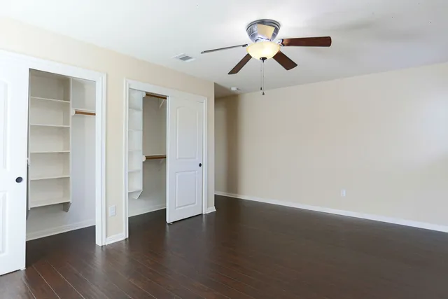 a view of room with hardwood floor and ceiling fan