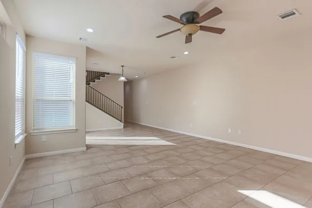 a view of a livingroom with a ceiling fan and window