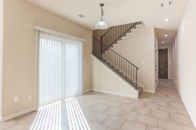 a view of entryway with a floor to ceiling window and stairs