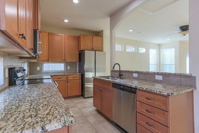 a kitchen with a sink refrigerator and microwave