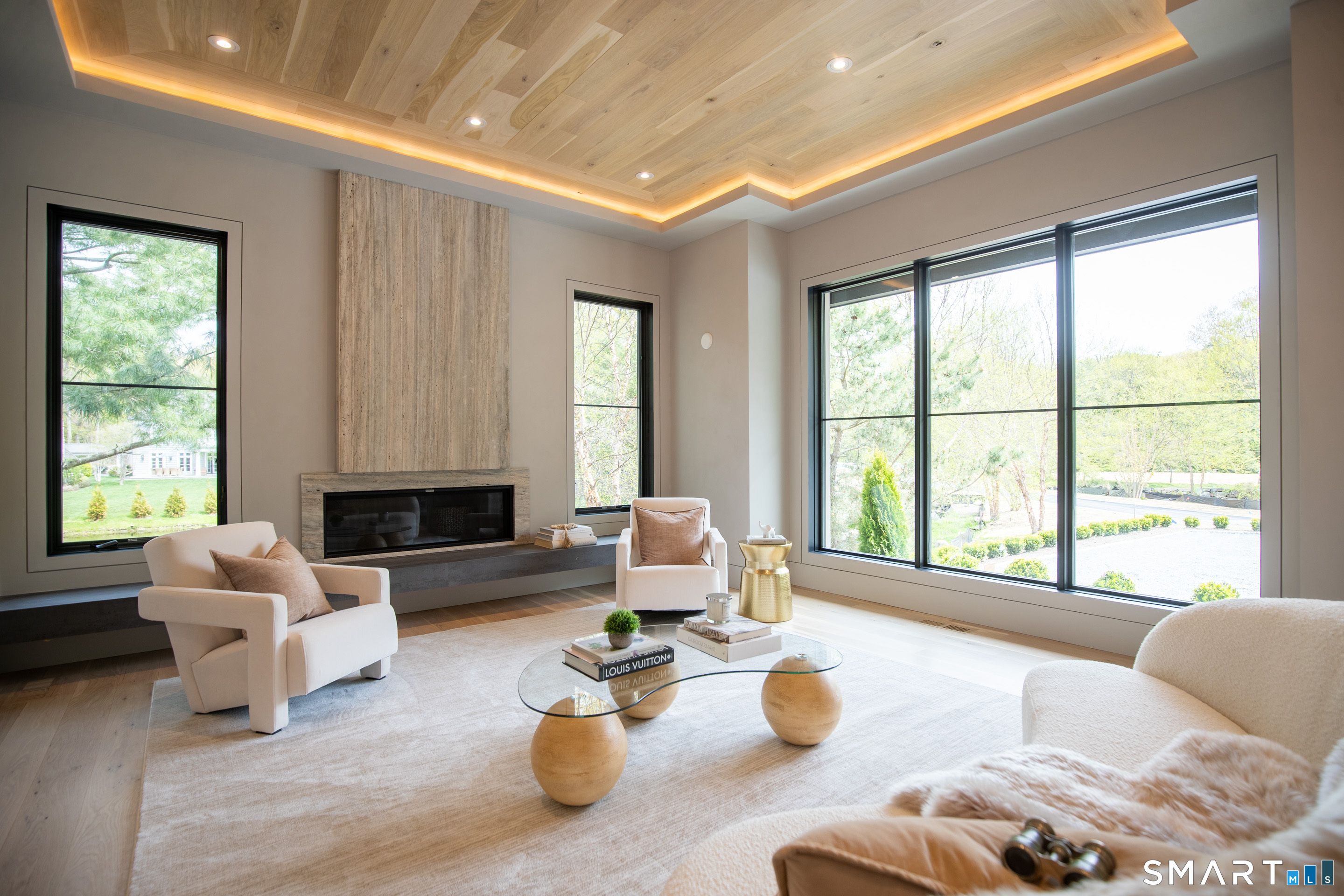 259 Frogtown Road New Canaan, CT 06840 - Photo 11 of 39 A living room with a gas fireplace and a room to live in.