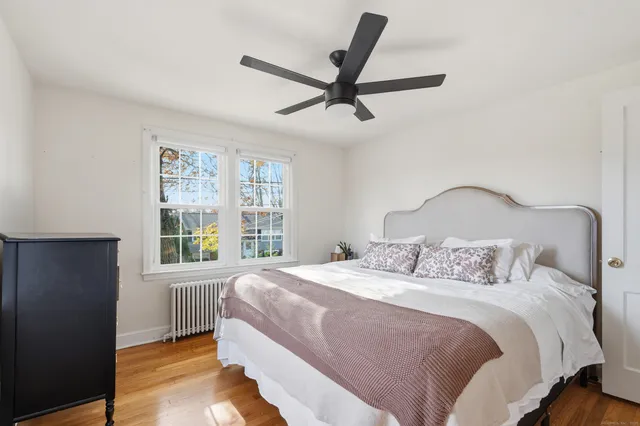 a bedroom with a large bed and a window