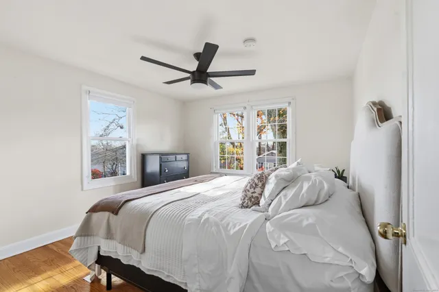 a bedroom with a large bed and a window