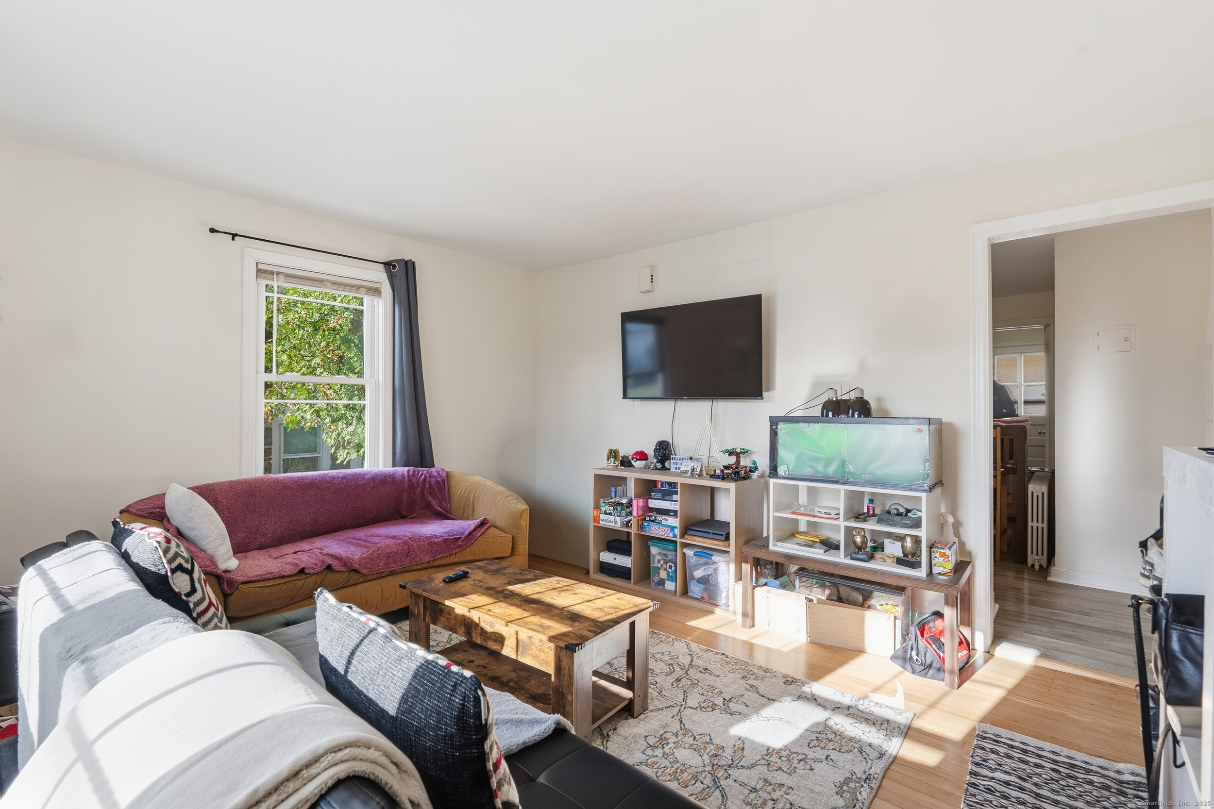 144 Warsaw Street Fairfield, CT 06825 - Photo 20 of 39 a living room with furniture and a flat screen tv