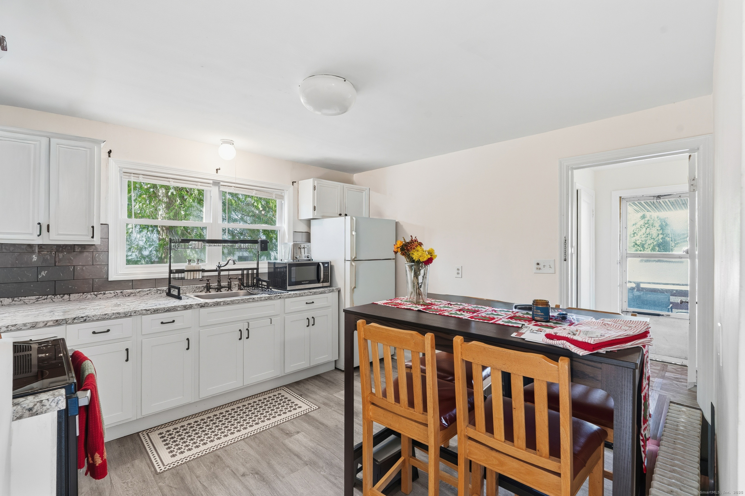 144 Warsaw Street Fairfield, CT 06825 - Photo 23 of 39 a kitchen that has a table and chairs in it