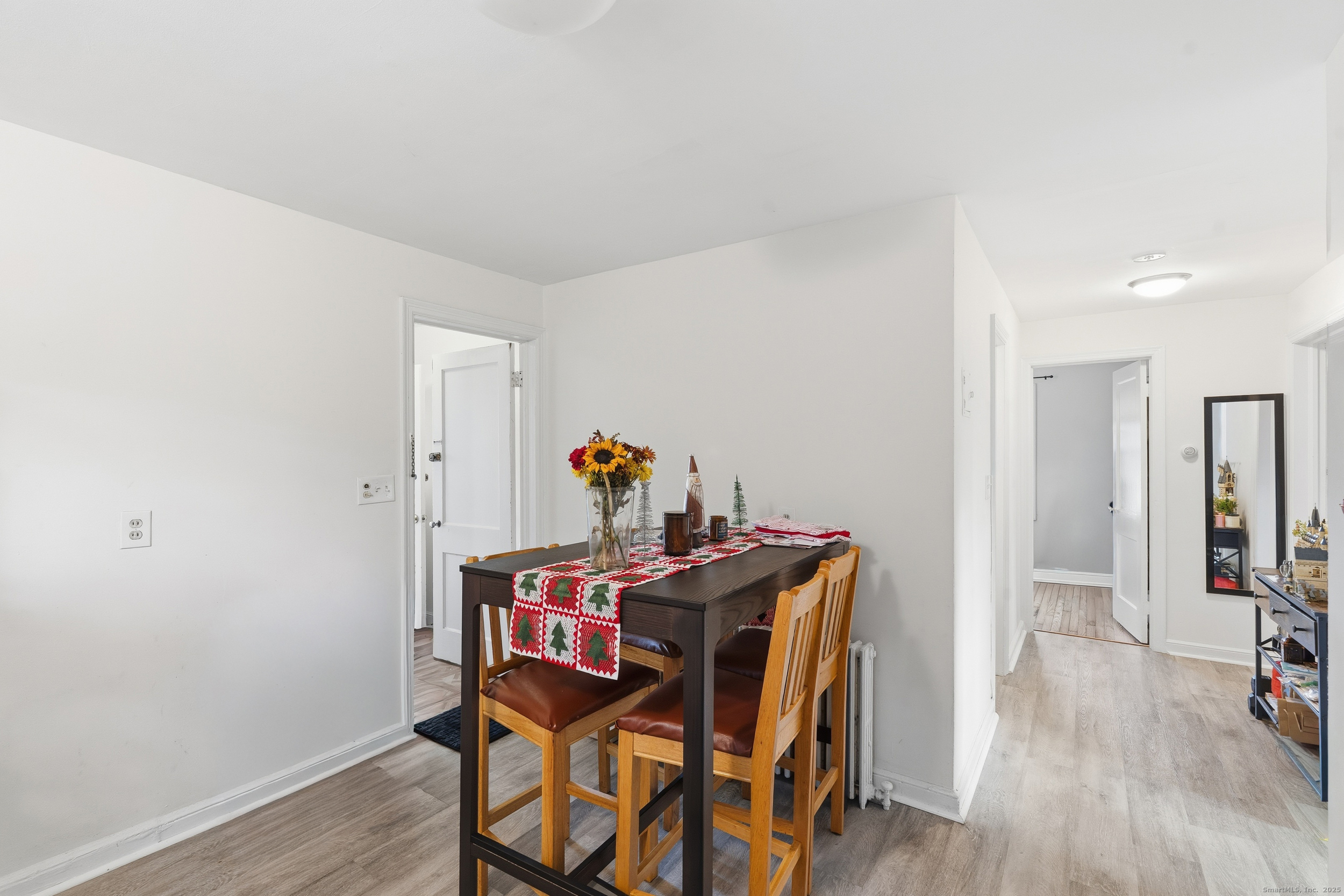 144 Warsaw Street Fairfield, CT 06825 - Photo 26 of 39 a view of a dining room with furniture and wooden floor