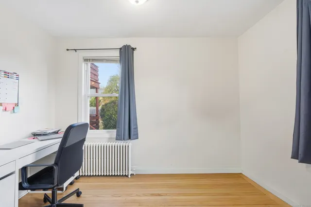 a view of a room with a wooden floor and a window