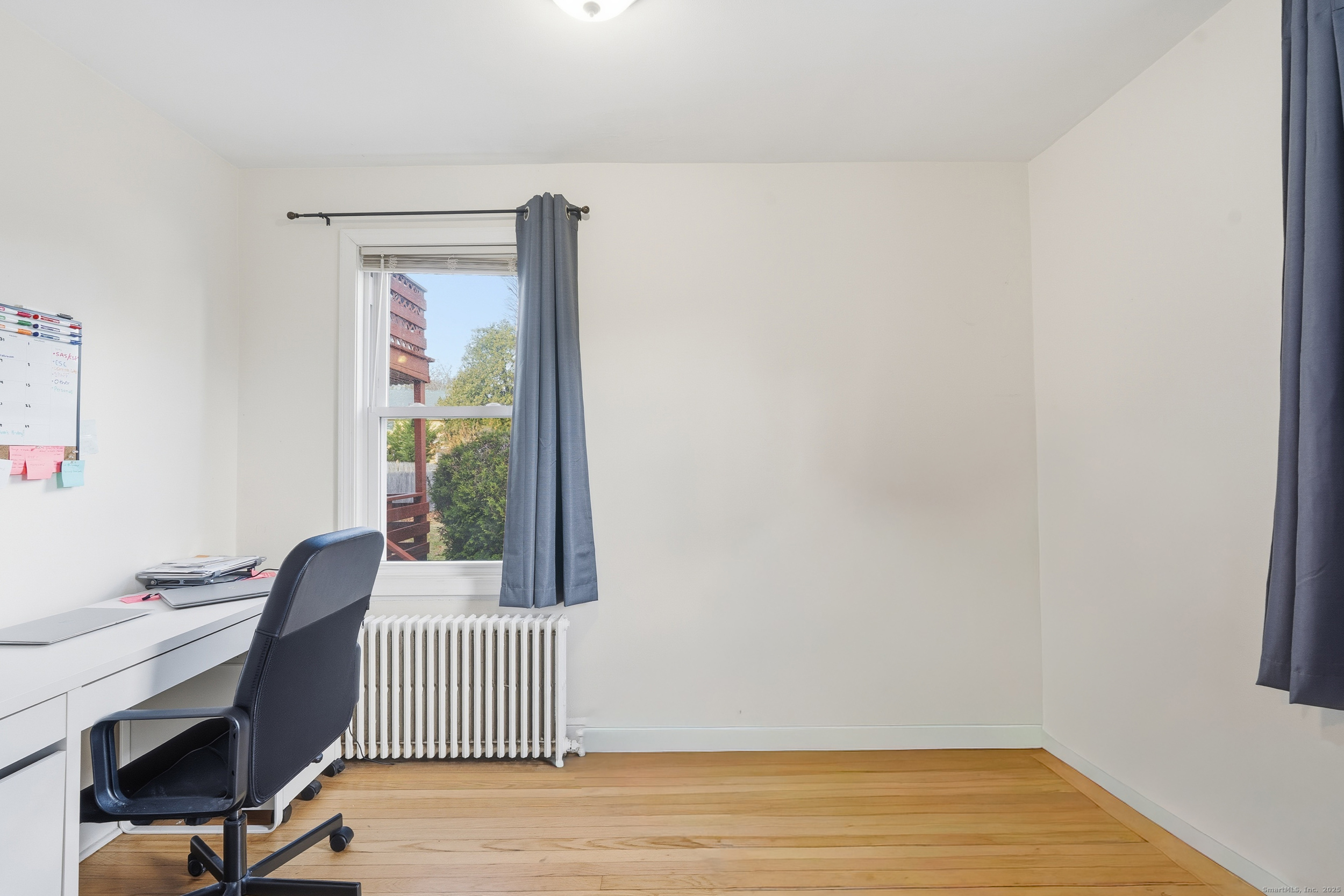 144 Warsaw Street Fairfield, CT 06825 - Photo 28 of 39 a view of a room with a wooden floor and a window