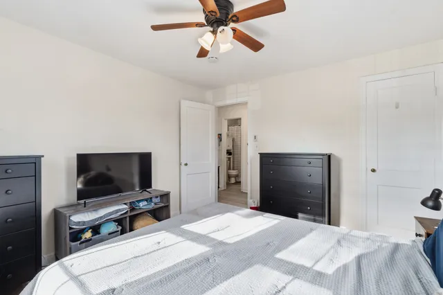a bedroom with a bed and a flat screen tv