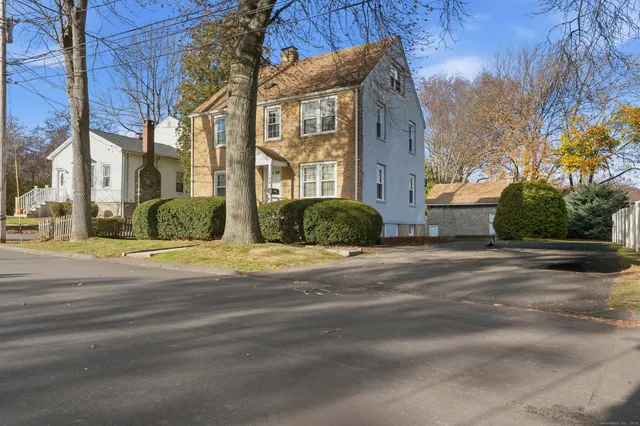 a view of a brick building next to a road