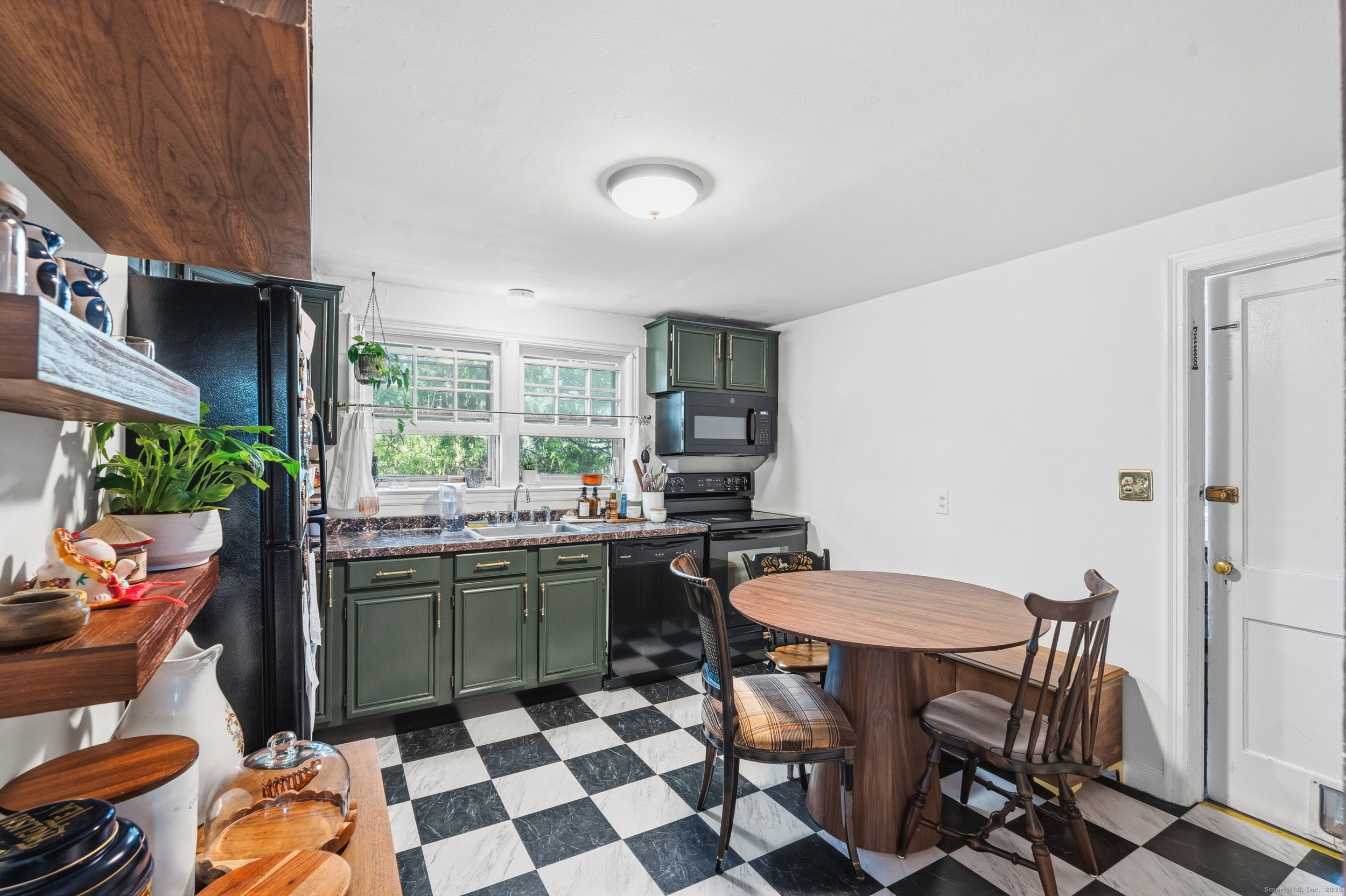 144 Warsaw Street Fairfield, CT 06825 - Photo 6 of 39 a kitchen with a sink a stove a dining table and chairs