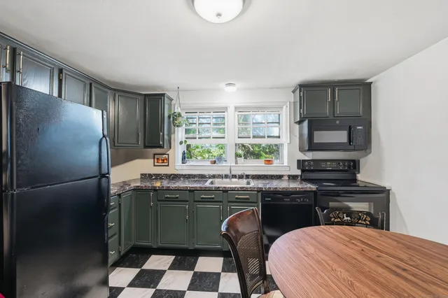 a kitchen with a sink a stove a refrigerator and cabinets