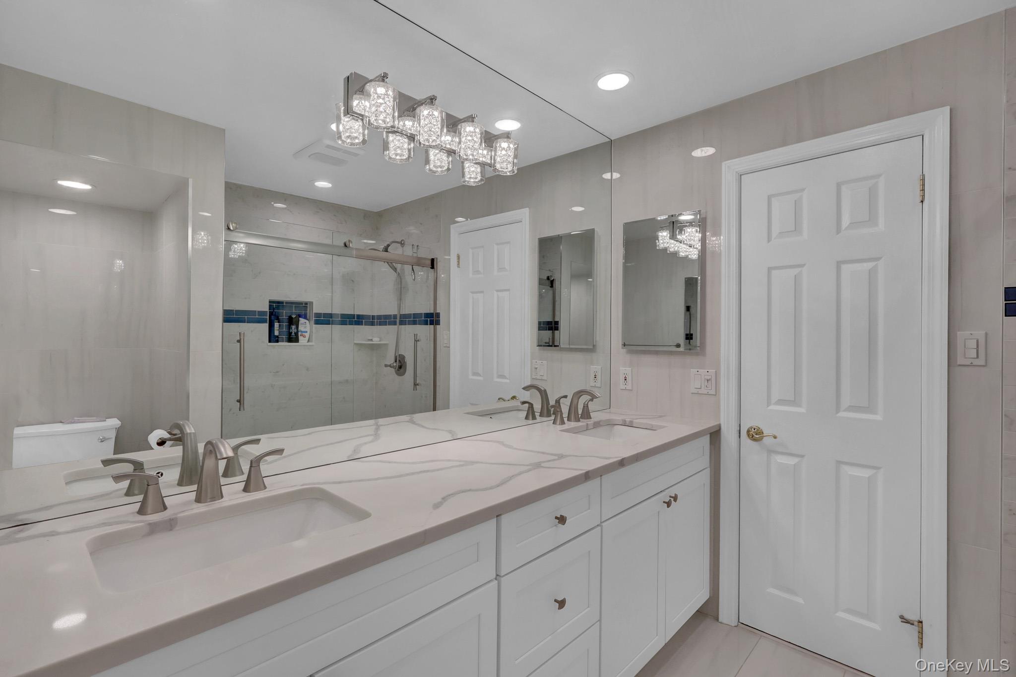 15 Stillwater Road Nissequogue, NY 11780 - Photo 19 of 43 Dual vanity with integrated sinks, brushed nickel fixtures, and a light-toned countertop