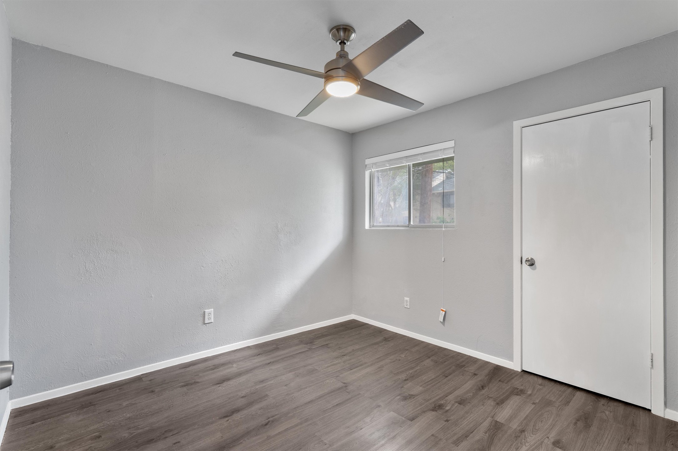 3415 Menchaca Road, Unit 113 Austin, TX 78704 - Photo 15 of 21 an empty room with wooden floor and windows