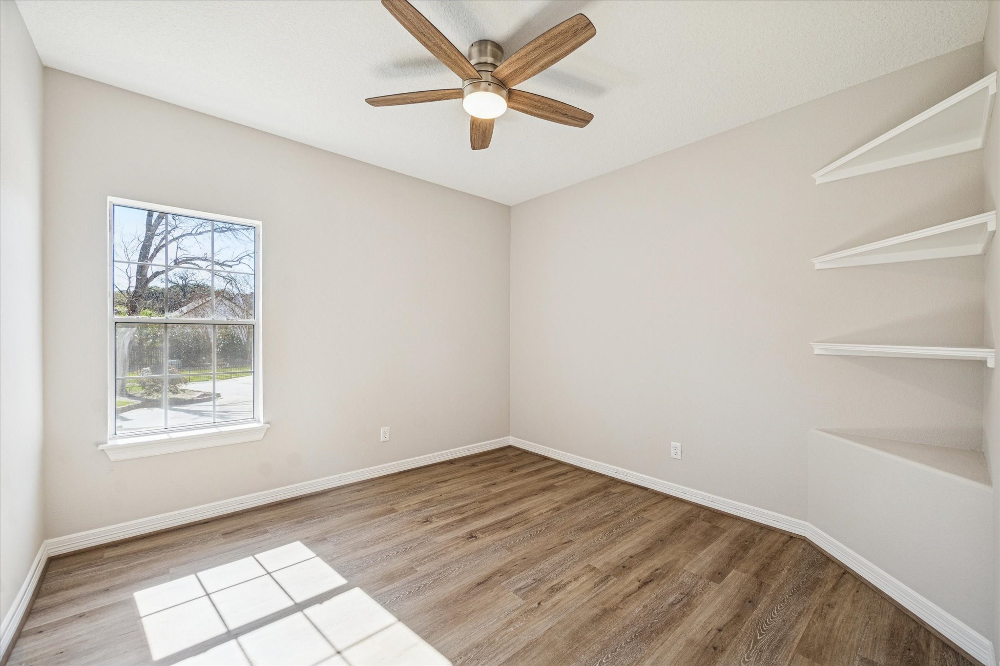 5437 Edgewater Court Willis, TX 77318 - Photo 22 of 29 an empty room with windows and fan