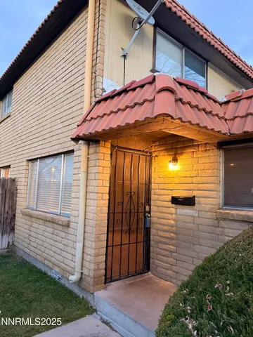 a view of a house with a small yard