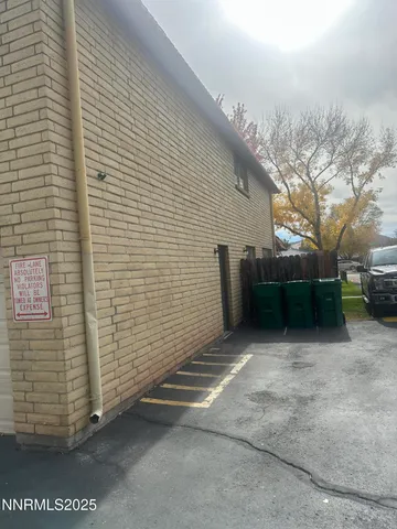 a view of backyard with wooden fence