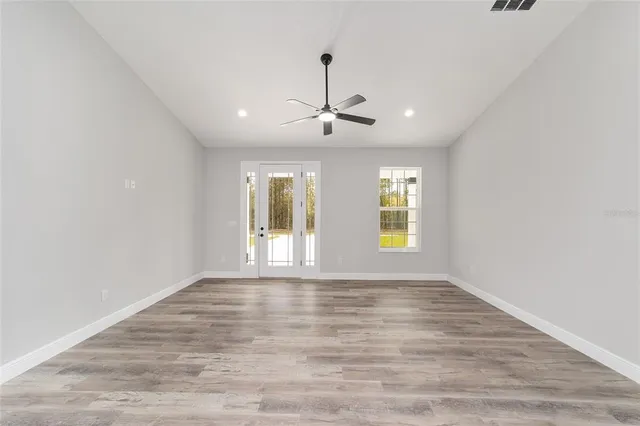 a view of a kitchen counter space a sink wooden floor and a window