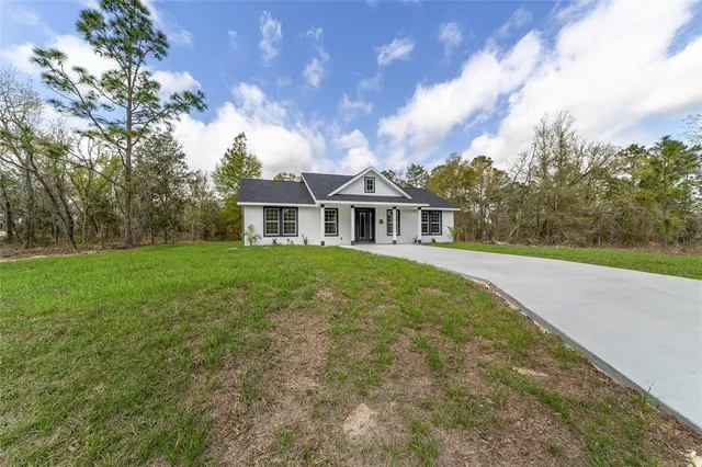 a view of kitchen with kitchen island wooden floor center island and stainless steel appliances