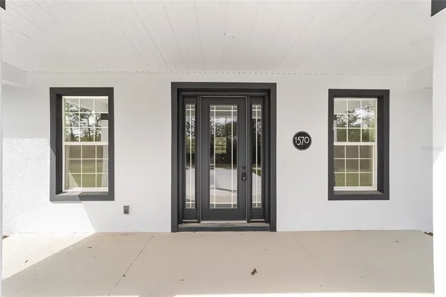 a view of kitchen with stainless steel appliances refrigerator stove microwave and cabinets