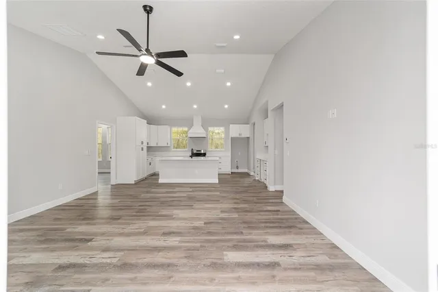 a kitchen with white cabinets appliances and sink