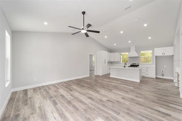 a kitchen with granite countertop a sink stainless steel appliances and cabinets