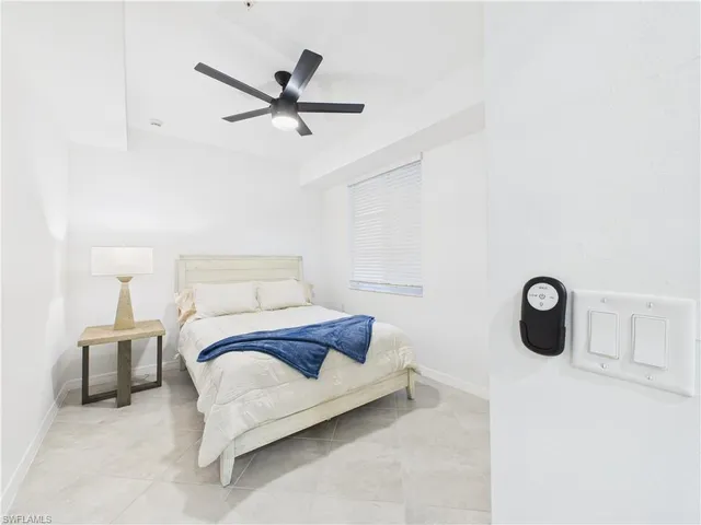 a bedroom with a bed and painting on the wall