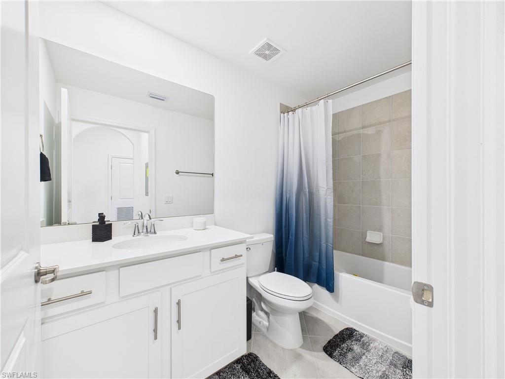 5527 Double Eagle Circle, Unit 3817 Ave Maria, FL 34142 - Photo 16 of 26 a bathroom with a sink a toilet and shower