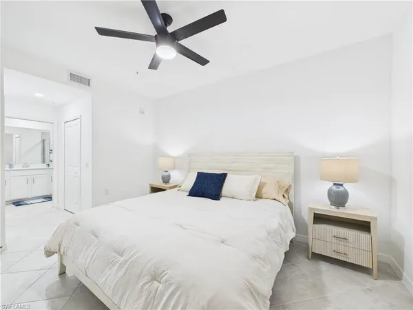 a bedroom with a bed and a painting on the wall