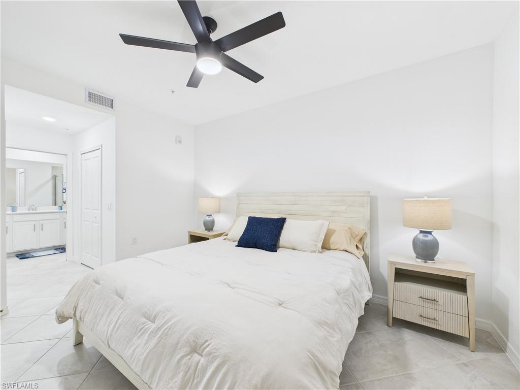 5527 Double Eagle Circle, Unit 3817 Ave Maria, FL 34142 - Photo 8 of 26 a bedroom with a bed and a painting on the wall