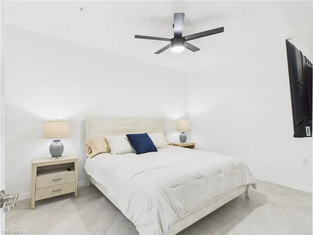 a bedroom with bed and a tv