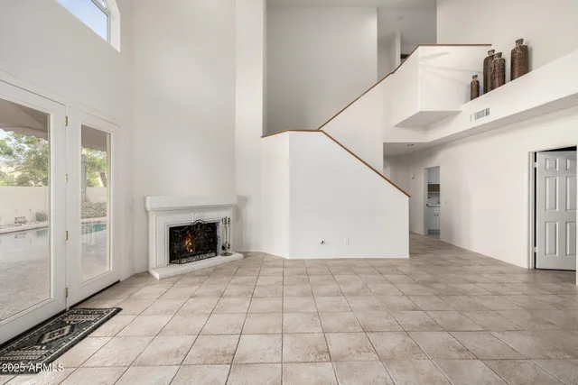 a view of a bedroom with wooden floor and windows