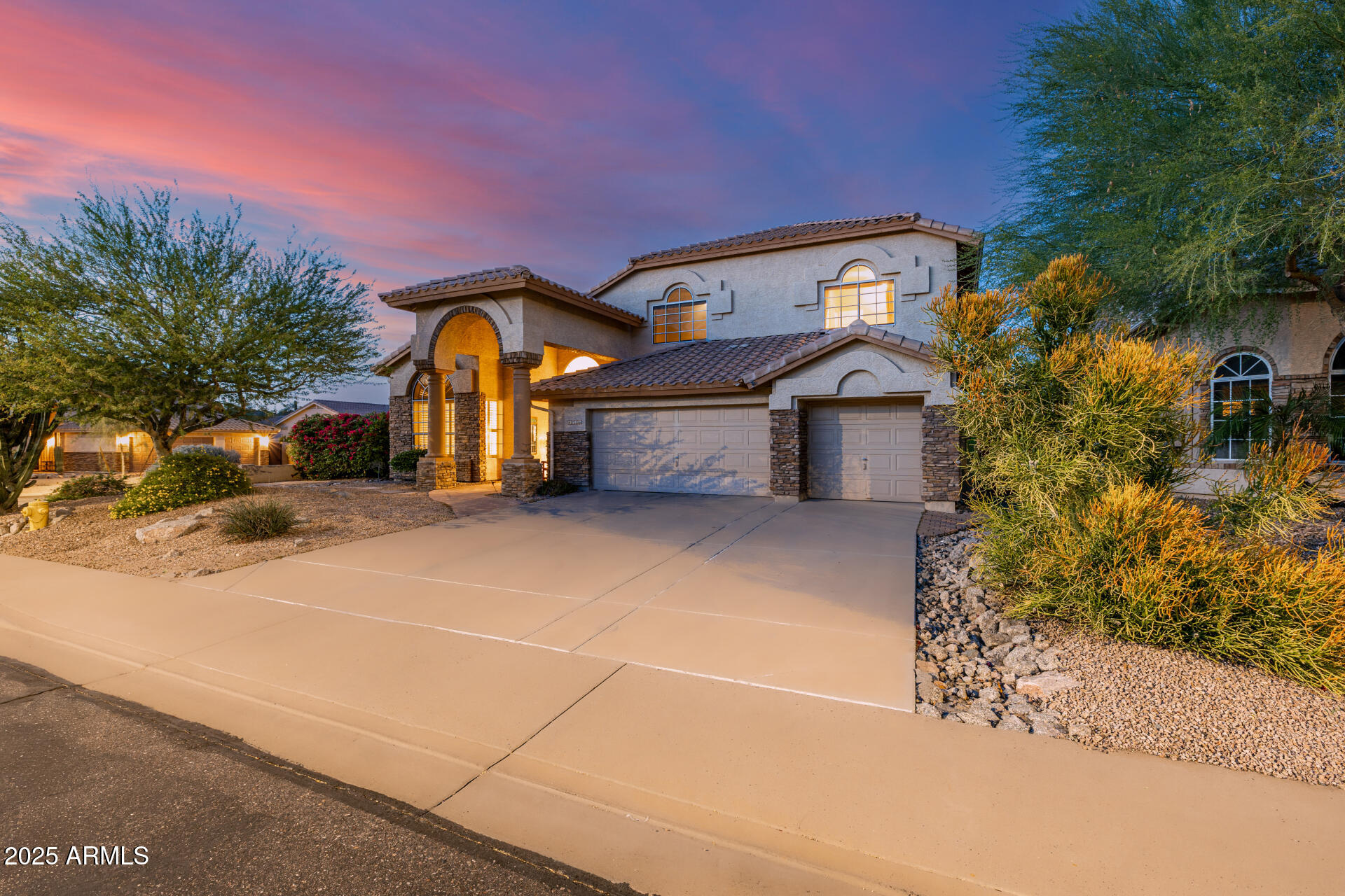 6726 East Villeroy Circle Mesa, AZ 85215 - Photo 3 of 74 a front view of a house with a yard and garage