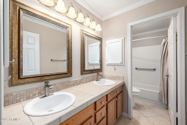 a bathroom with a granite countertop toilet sink and mirror
