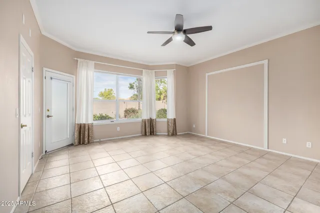 an empty room with a empty space and a ceiling fan