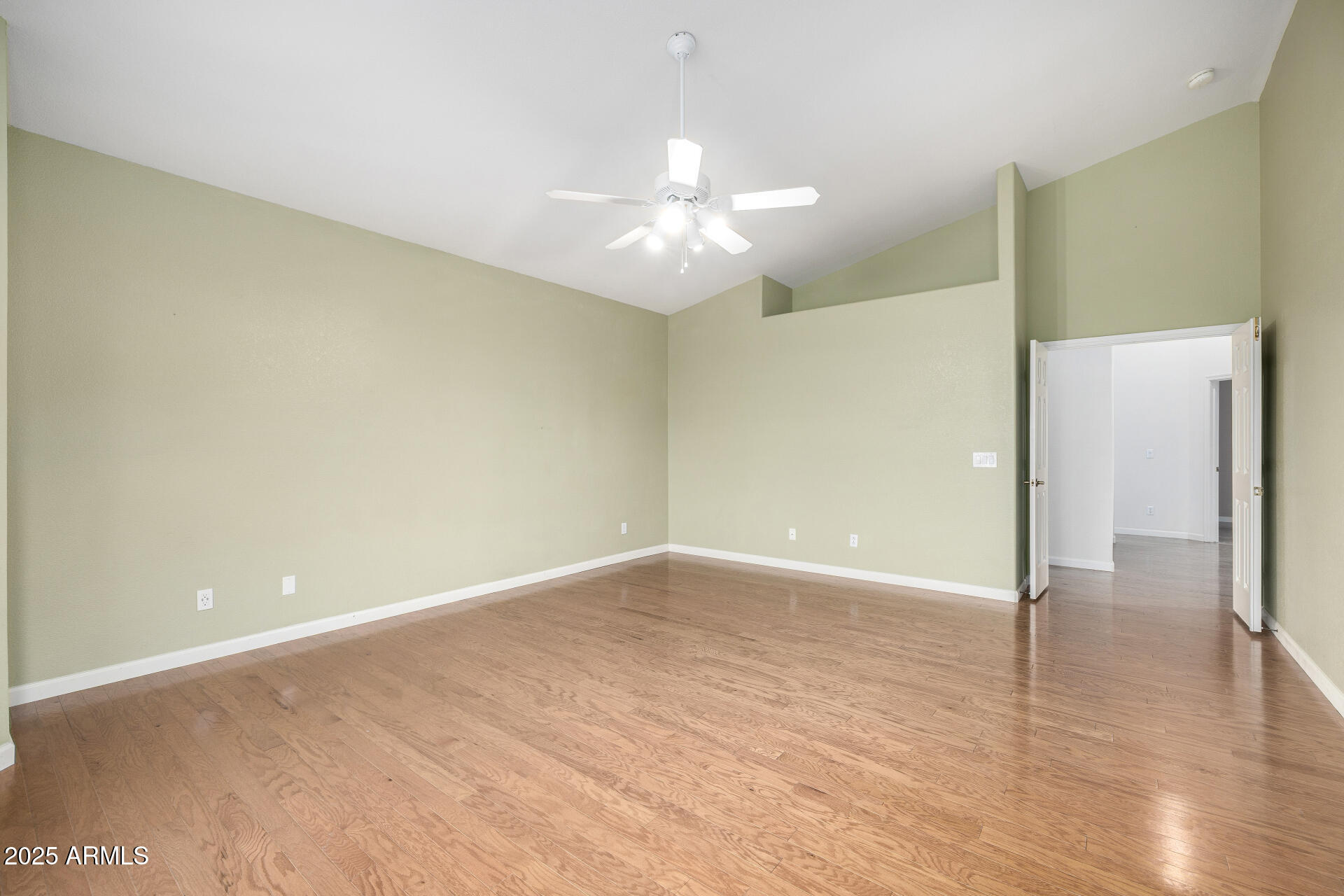 6726 East Villeroy Circle Mesa, AZ 85215 - Photo 45 of 74 a view of an empty room with wooden floor and a ceiling fan