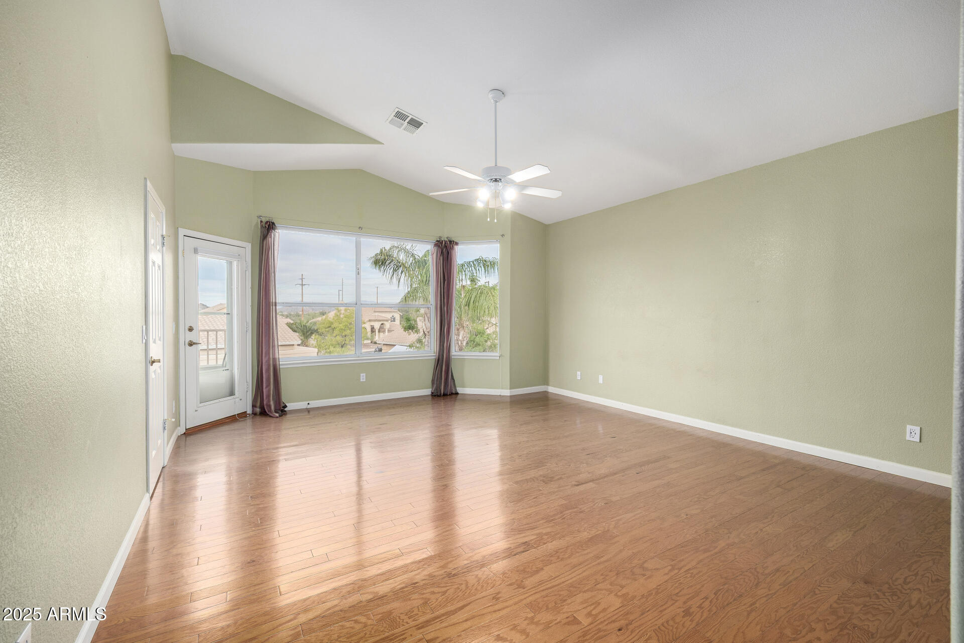 6726 East Villeroy Circle Mesa, AZ 85215 - Photo 46 of 74 wooden floor in an empty room with a window