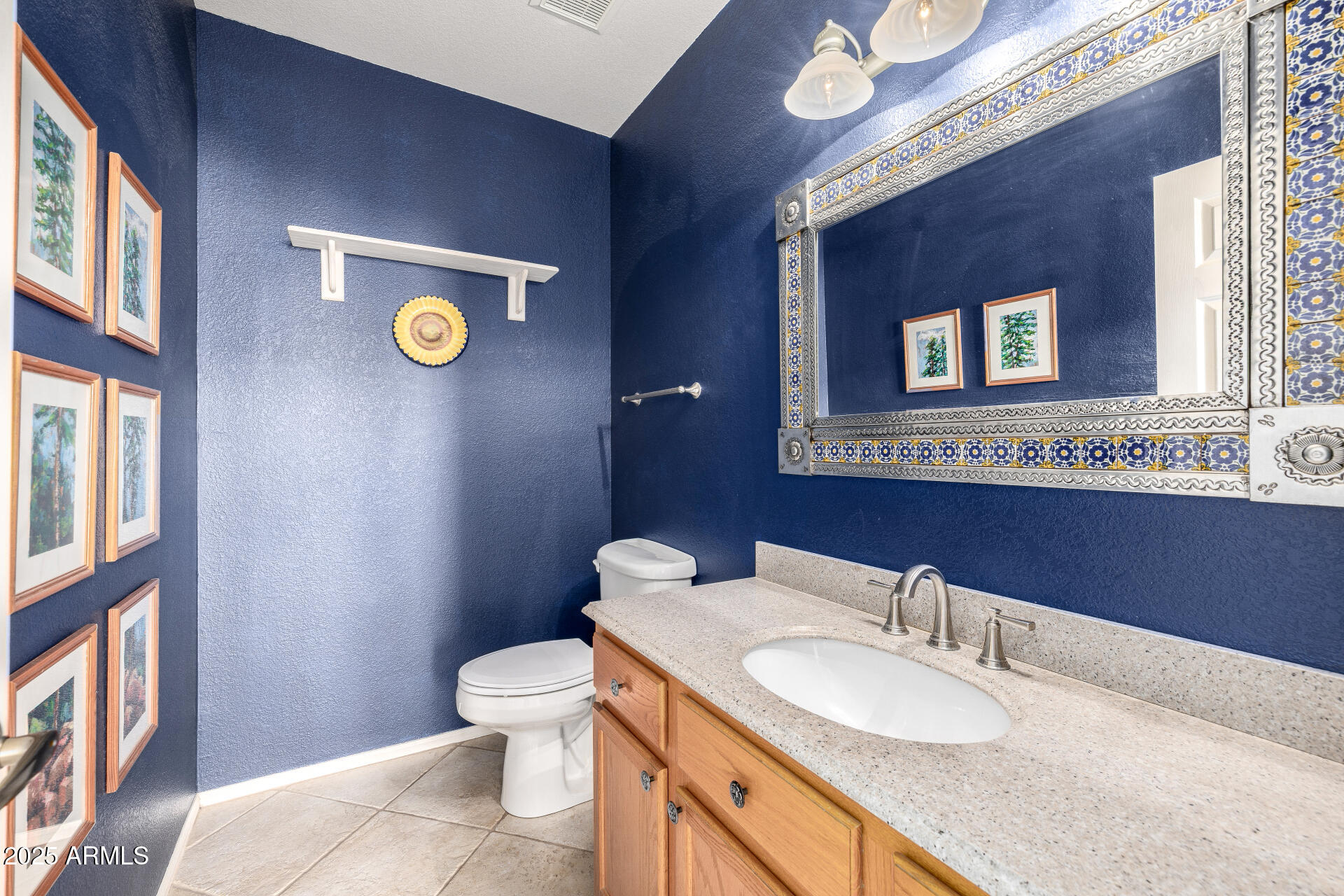 6726 East Villeroy Circle Mesa, AZ 85215 - Photo 47 of 74 a bathroom with a granite countertop toilet sink and mirror