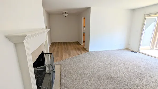 an empty room with wooden floor and a window