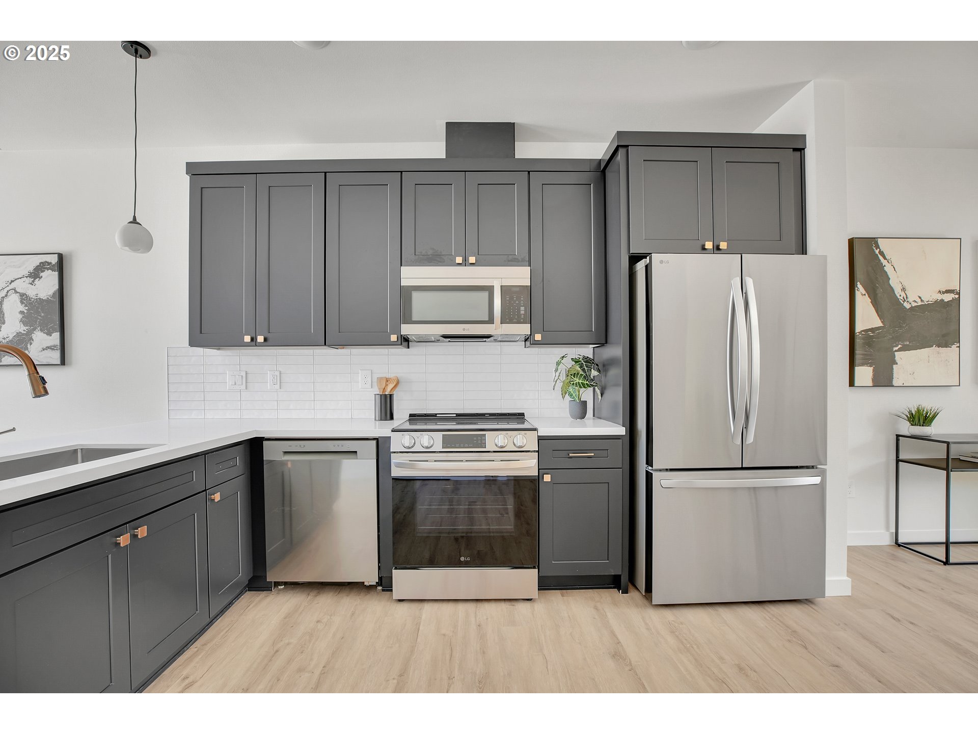 14828 Northeast Couch Street, Unit 5 Portland, OR 97230 - Photo 15 of 48 a kitchen with granite countertop a refrigerator stove top oven and cabinets