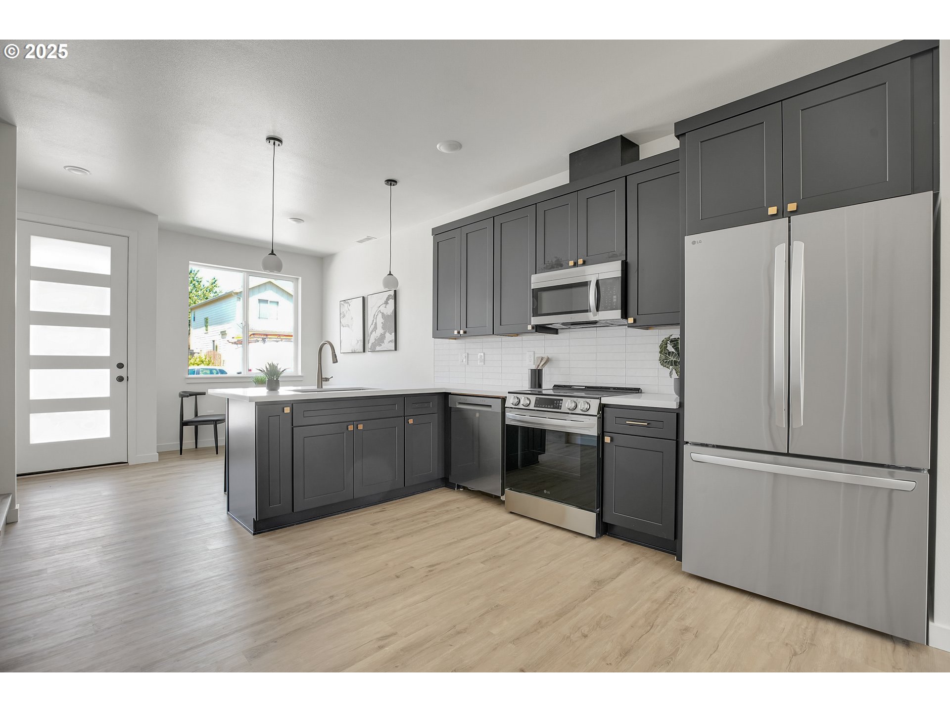 14828 Northeast Couch Street, Unit 5 Portland, OR 97230 - Photo 34 of 48 a kitchen with granite countertop a refrigerator stove top oven and sink