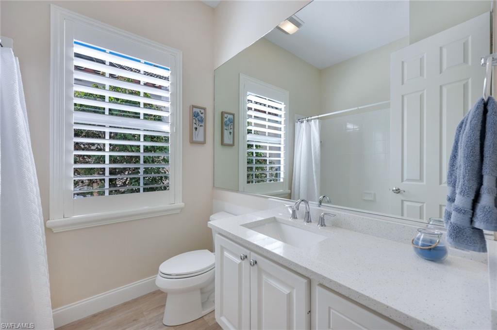 3108 Dominica Way Naples, FL 34119 - Photo 16 of 39 Bathroom vanity with a white countertop and integrated sink