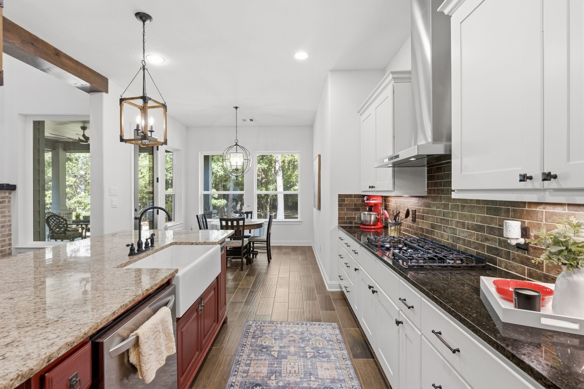 248 Fire Sky Road Huntsville, TX 77340 - Photo 12 of 36 The kitchen flows seamlessly into the sunlit breakfast room, with large windows framing the surrounding trees and bringing the outdoors in.