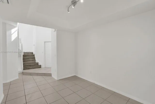 a view of an empty room with stairs