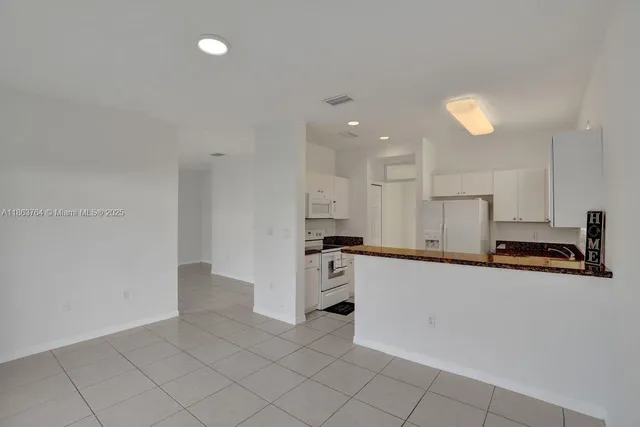 a kitchen with a stove a refrigerator and a sink
