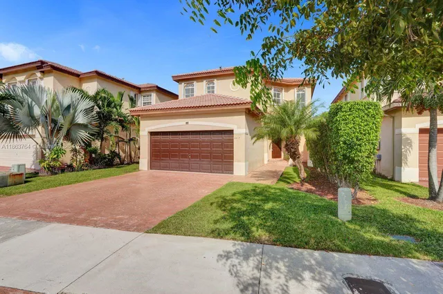 a front view of a house with a yard and garage
