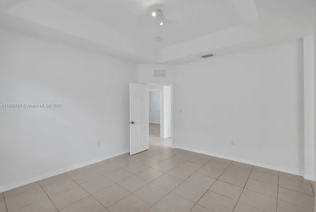 a front view of multiple houses with palm trees